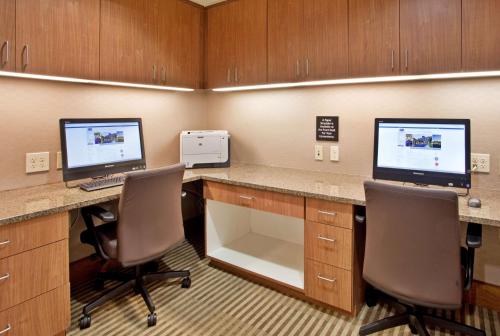 an office with two computers on a desk with two chairs at Hampton Inn & Suites Phoenix Glendale-Westgate in Glendale