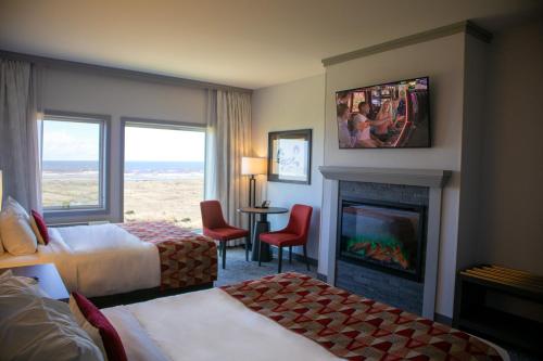 a hotel room with two beds and a fireplace at Quinault Beach Resort & Casino in Ocean Shores