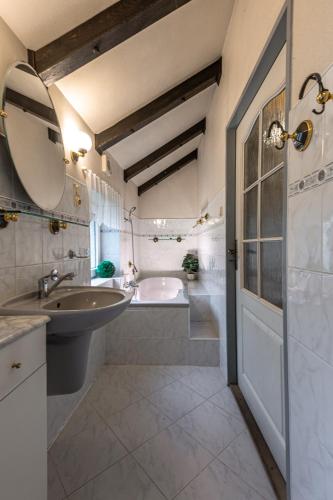 a bathroom with a sink and a bath tub at Chata Zvoneček in Jiřetín pod Jedlovou