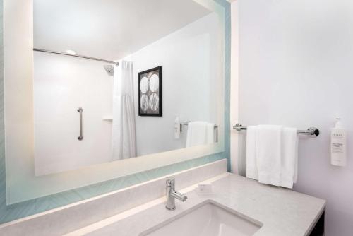 a bathroom with a sink and a mirror at Hilton Garden Inn Charlotte Uptown in Charlotte