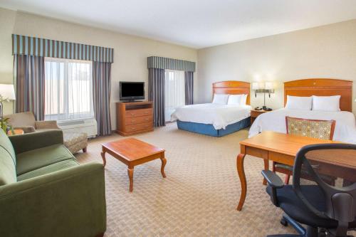 a hotel room with a bed and a living room at Hampton Inn Santa Rosa in Santa Rosa