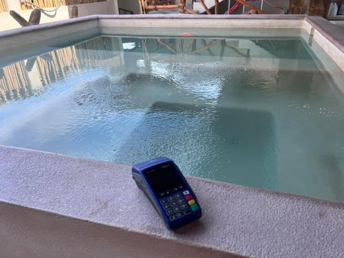 a remote control sitting in a pool of water at Hotel Casa-Noria Acapulco in Acapulco