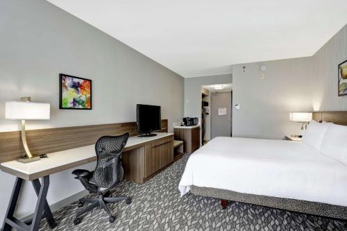 a hotel room with a bed and a desk at Hilton Garden Inn Toronto/Ajax in Ajax