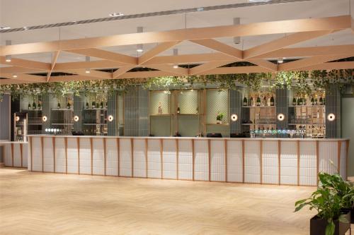 a rendering of the lobby of a restaurant with a bar at Radisson Blu Royal Hotel Dublin in Dublin