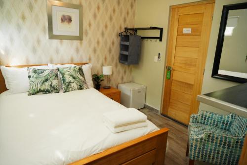 a bedroom with a bed and a wooden door at Hostal 53 Boutique Santo Domingo in Santo Domingo