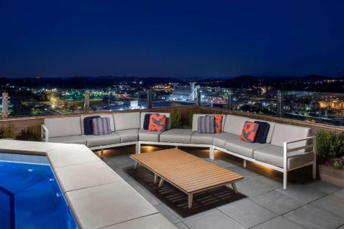 a patio with couches and a table on a roof at Embassy Suites By Hilton Knoxville Downtown in Knoxville