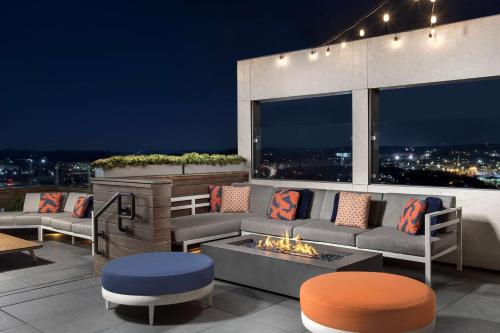 a patio with couches and a fire pit on a roof at Embassy Suites By Hilton Knoxville Downtown in Knoxville