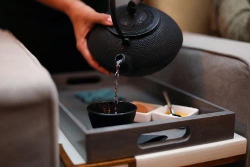 a person pouring water into a cup in a box at Embassy Suites By Hilton Knoxville Downtown in Knoxville