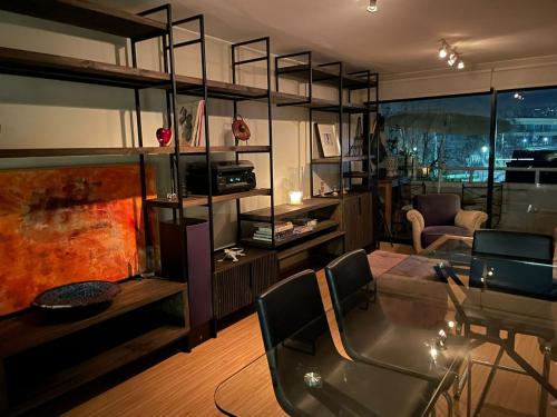 a living room with a glass table and a couch at Departamento Delux in Santiago