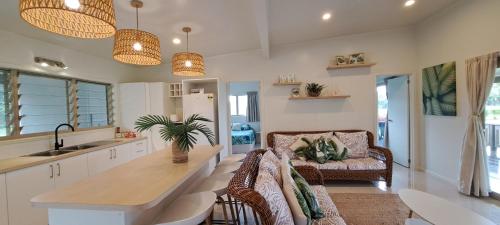a kitchen with a couch and a table in a room at Serene Holiday Home in Rarotonga