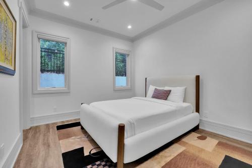 a white bedroom with a large white bed in it at Atl Royal in Atlanta