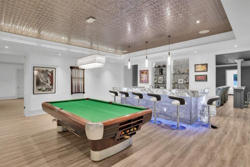 a gaming room with a pool table and chairs at Atl Royal in Atlanta