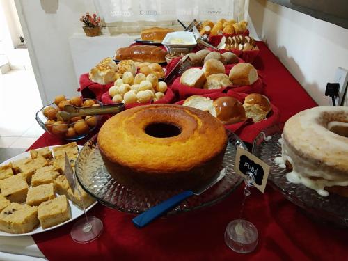 a table filled with different types of pastries and cakes at Pousada Linda Borboleta in Conservatória