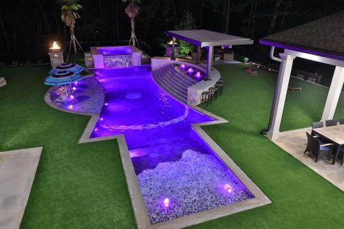 a swimming pool with purple lights in a yard at Atl Royal in Atlanta