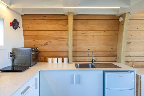 a kitchen with wooden walls and a sink at Moonrise on Seaview in Palm Beach