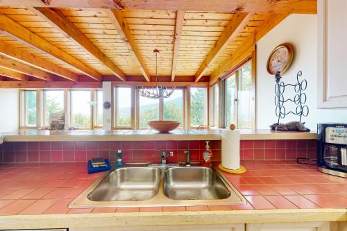 cocina con fregadero y algunas ventanas en Lincoln Peak Retreat, en Warren