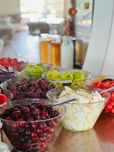 a table topped with bowls of fruits and vegetables at Vila Luz in Luz