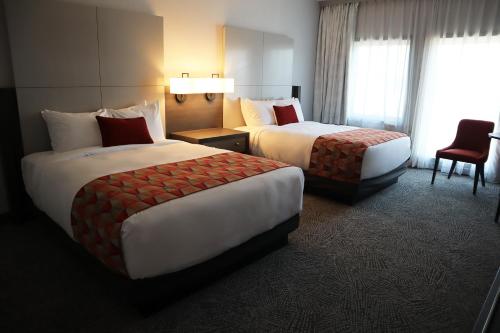 a hotel room with two beds and a chair at Quinault Beach Resort & Casino in Ocean Shores