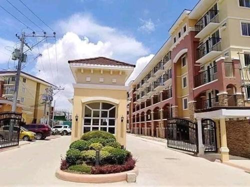 a building on a city street with a building at Arezzo Place Condo in Davao City