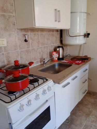 a kitchen with two pots on top of a stove at My House in El Calafate. in El Calafate