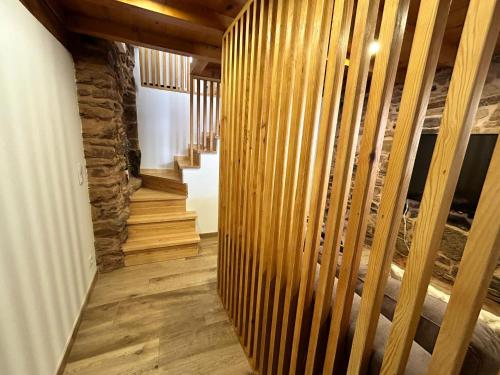 a hallway with wooden walls and wooden stairs at Casa d'avó Coragem in Seia