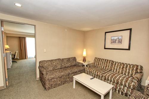 a living room with a couch and a table at Holiday Inn Leon-Convention Center by IHG in León