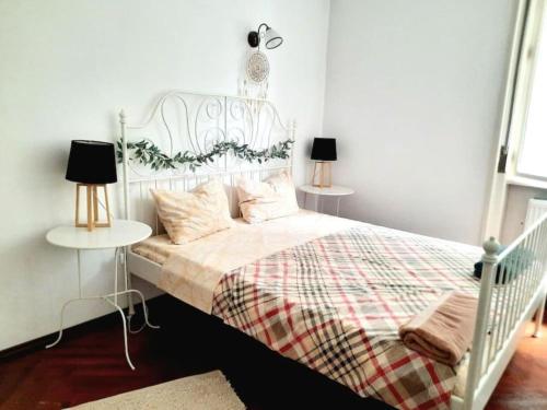 a bedroom with a white bed with a plaid blanket at Old Town Central 2 Bedroom Oasis in Timişoara