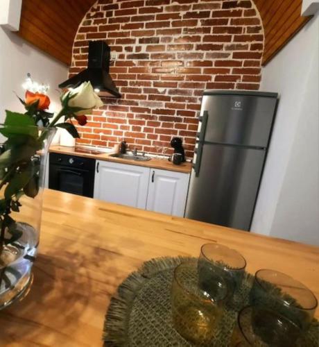 a kitchen with a refrigerator and a wooden table at Timisoara Central 2 Bedroom Hotel Serviced Belle Vue Apart By the Park in Timişoara