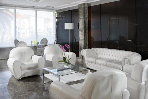 a living room with white couches and a table at Santemar in Santander