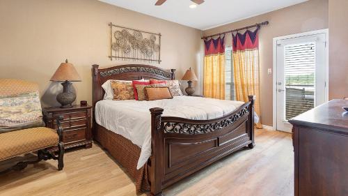 a bedroom with a large bed and a window at Lake Travis Stunning Waterfront, Sunset & Pool Views, Pet Friendly, Boat Ramp, Lago Vista, Texas in Lago Vista