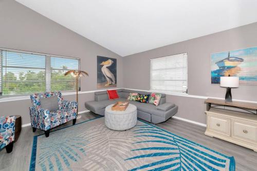 a living room with a couch and chairs and a table at Walk to the beach - Island Villa in Siesta Key