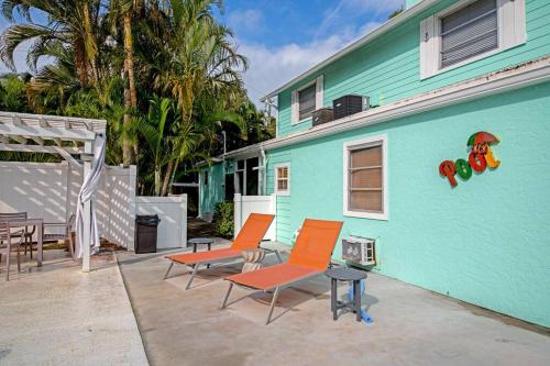 a group of chairs sitting outside of a house at Walk to the beach - Island Villa in Siesta Key