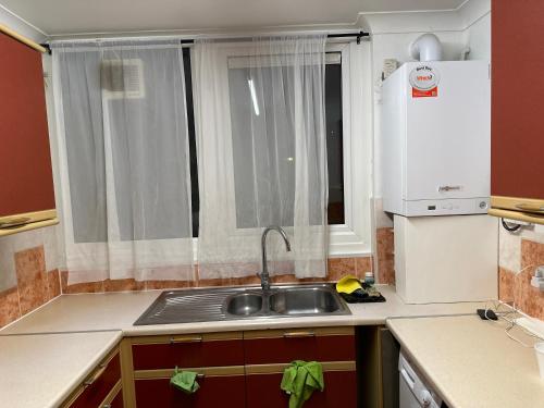 a small kitchen with a sink and a window at Rooftop Apartment in Crystal Palace