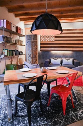 a wooden table and chairs in a living room at Canela Fina - Adults Only in San Miguel de Allende