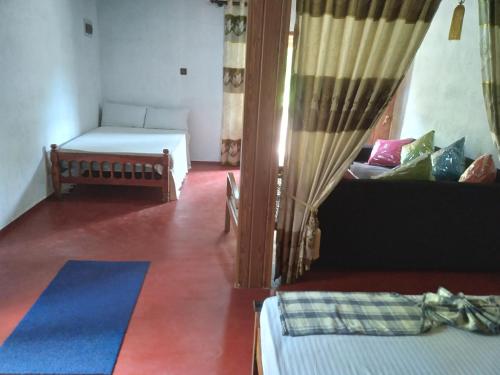 a living room with a bed and a couch at Peacock Residence & Cabana's in Tangalle