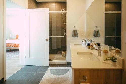 a bathroom with a sink and a shower at NEW Luxury 1BR Penthouse Apt In Central Halifax in Halifax