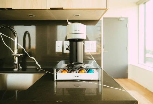 a kitchen counter with a mixer and a bowl of fruit at NEW Luxury 1BR Penthouse Apt In Central Halifax in Halifax