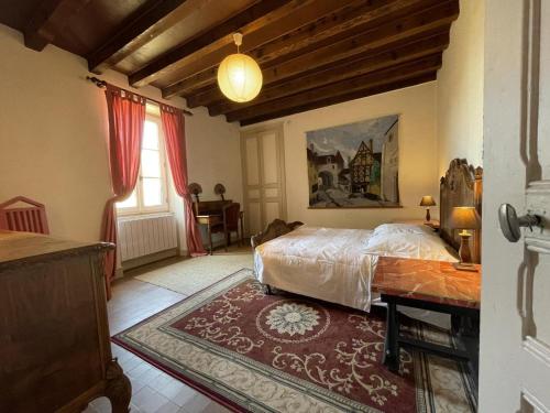 Un dormitorio con una cama y una mesa. en Gîte Chappes (Allier), 4 pièces, 6 personnes - FR-1-489-90, en Chappes