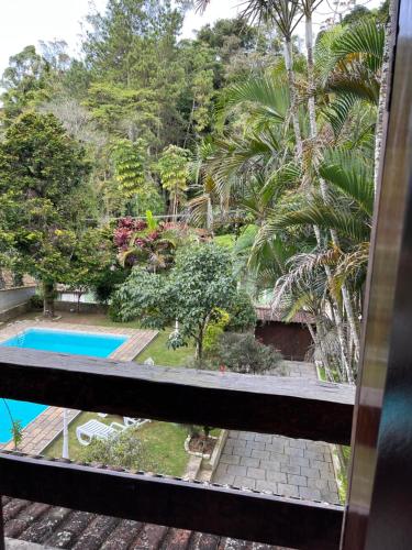 a view from the balcony of a resort with a swimming pool at Hostel Recanto Aurora in Petrópolis