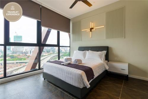 une chambre avec un grand lit et de grandes fenêtres dans l'établissement Scarletz Suites KLCC, Travelet, à Kuala Lumpur