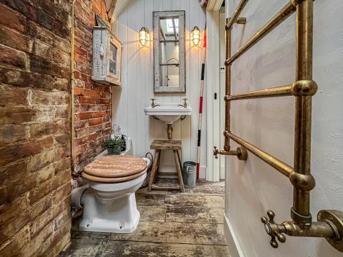 a bathroom with a toilet and a sink at Campbell Cottage in Ticehurst