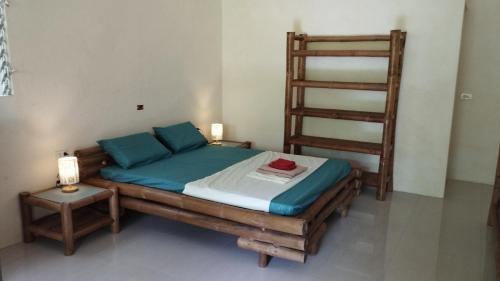 a bedroom with a wooden bed with a ladder at ACACIA'S Cottages mit Starlink Wifi in Mambajao