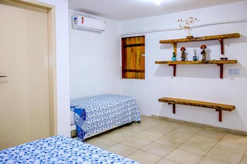 a room with two beds and a table on the wall at Casa Cacto - Ilha do Ferro AL in Pão de Açúcar