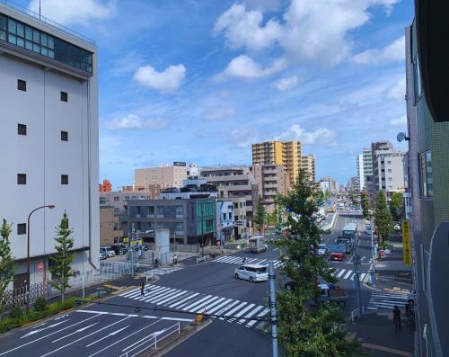 a view of a city street with cars on the road at Beagle Tokyo Hostel＆Apartments in Tokyo