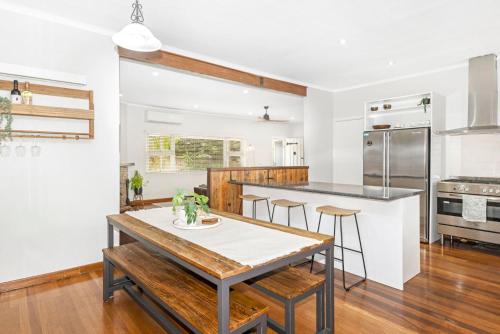 a kitchen with white walls and a table and chairs at Ashdene Busselton in Busselton