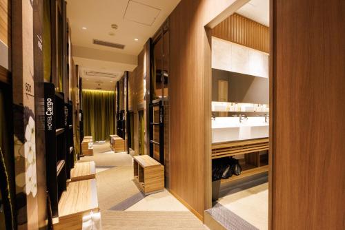 a hallway of a dressing room with a sink at HOTEL Cargo Shinsaibashi in Osaka