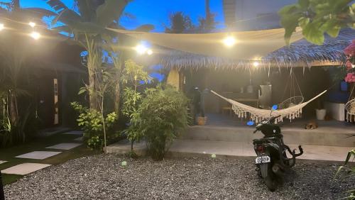a motorcycle parked in front of a house at night at Yay Lodge SIARGAO, private room 1 with AC & hot shower and fast Starlink Wifi in General Luna