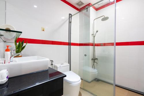 een badkamer met een wastafel, een douche en een toilet bij 21's Homestay in Hanoi