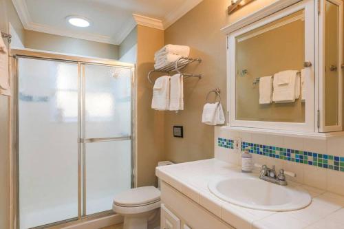 a bathroom with a toilet and a sink and a shower at Trinity By Palm House Hospitality Stays in Glen Ellen