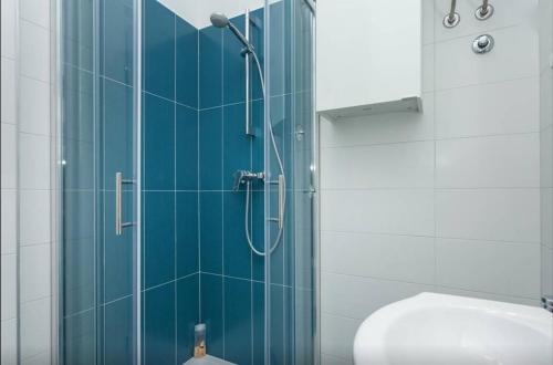 a bathroom with a glass shower with a toilet at Studio Stella in Rovinj